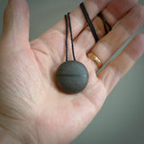 A drop pendant made from Onewa Stone - New Zealand Greywacke - with a fine Pounamu insert spliced into the middle.