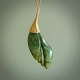 This is a unique flower pendant, hand carved from New Zealand Jade. The cord is a creme colour and is length adjustable. This is delivered to you with Express Courier. Hand carved Jade necklace replicating a flower blossom from Donna Summers.