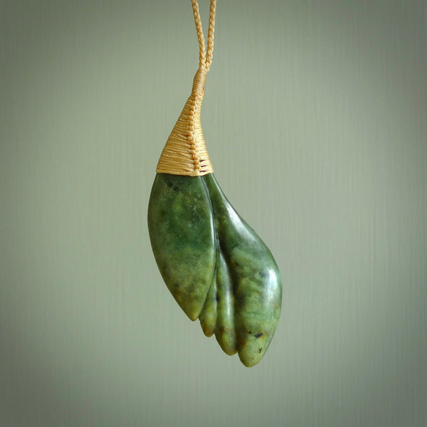 This is a unique flower pendant, hand carved from New Zealand Jade. The cord is a creme colour and is length adjustable. This is delivered to you with Express Courier. Hand carved Jade necklace replicating a flower blossom from Donna Summers.