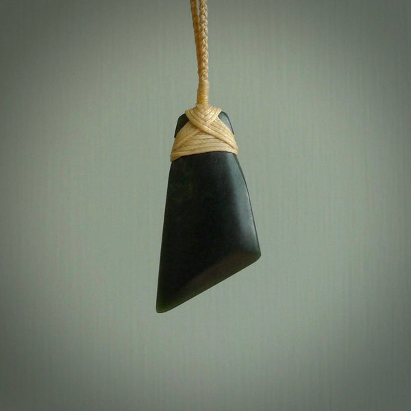 Hand carved from a lovely piece of local New Zealand Jade. The quality of the workmanship and design is outstanding - this is a piece you will want to wear all the time. We have suspended this from a 3-plait beige cord which can be adjusted with a couple of slip knots and beige binding.