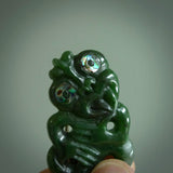 This is a medium sized tiki - carved from gorgeous Marsden jade. The craftsmanship is superb, this piece is as well carved as any we have seen. The cord is an adjustable plaited cord in black.