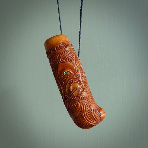 A traditional hand carved Māori Kōauau flute. This piece is made from bone and is a fully functioning musical instrument and can be played. Beautiful ethnic art hand made by NZ Pacific.