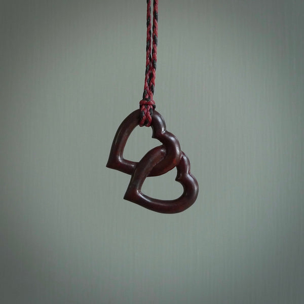 Hand carved double heart pendant made in black jade, green jade and jasper stone. Made by NZ Pacific. Carved from green jade, black jade and red jasper stone. Free delivery worldwide.