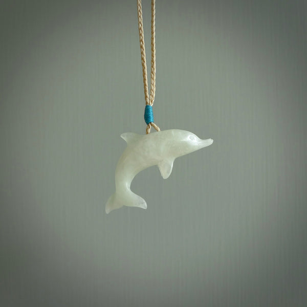 This is a gorgeous little dolphin pendant carved in jadeite. The cord is fine, hand-plaited and length adjustable so you can position the little jade dolphin where it suits you best. Shipping is free worldwide.