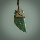 Hand carved from a lovely piece of local New Zealand Jade. The quality of the workmanship and design is outstanding - this is a piece you will want to wear all the time. We have suspended this from a 4-plait olive cord which can be adjusted with a couple of slip knots and olive binding.