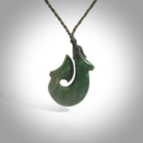 Hand carved New Zealand Flower Jade Hook pendant. New Zealand Flower Jade hook necklace. Real New Zealand Pounamu hook pendant for men and women. Free worldwide delivery.