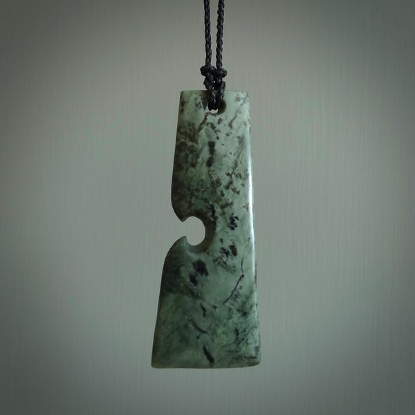 Hand carved from a lovely piece of local New Zealand Jade. The quality of the workmanship and design is outstanding - this is a piece you will want to wear all the time. We have suspended this from a 3-plait black cord which can be adjusted with a couple of slip knots and olive binding.