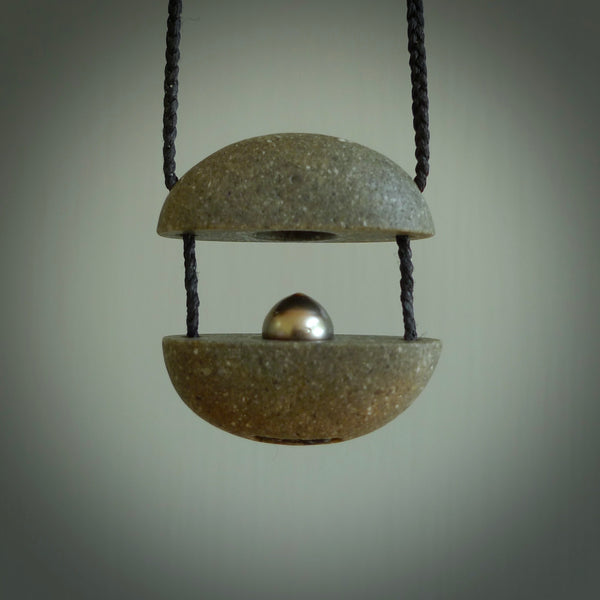 Greywacke stone pendant with Black Pearl insert. Hand carved by Rhys Hall for NZ Pacific. Handmade contemporary jewellery for sale online.