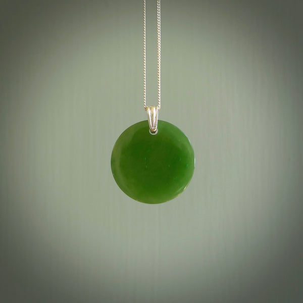 Hand made small British Columbian circle, drop pendant. Hand carved in New Zealand by Kerry Thompson. Hand made jewellery. Unique British Columbian Jade round drop pendant with sterling silver chain. Free shipping worldwide.