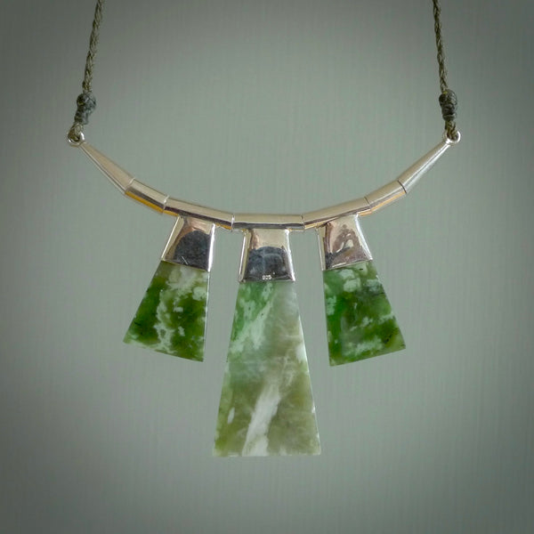 Hand crafted contemporary jade and sterling silver drop necklace. This necklace is provided with a fern green cord and silver clasp. Contemporary three jade drops necklace with sterling silver.