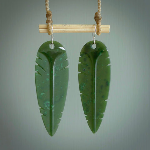 This picture shows British Columbian jade kaka feather earrings with sterling silver hooks. Hand made unique and contemporary feather earrings by Kerry Thompson. Hand carved here in New Zealand from British Columbian Jade. One pair only.