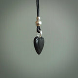 Hand carved heart pendant made in black jade and bone. Made by NZ Pacific. Carved from black jade and bone. Free delivery worldwide.