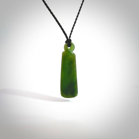 This pendant is a flower jade single twist. It is handcarved from New Zealand flower jade and has a mix of green, mint and pale gold colours interspersed throughout the stone. It has a fine twist, small and light. The cord is hand plaited and can be adjusted. The cord colour on this piece is Khaki. Two sizes available.