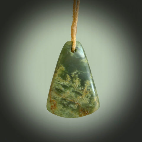 This is a lovely New Zealand Flower Jade, pounamu drop pendant. Hand carved for us by Ric Moor. It is bound with an adjustable beige coloured cord which is length adjustable. Free worldwide shipping.