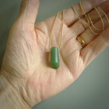 This picture shows a small hand carved jade drop pendant by Ric Moor. The jade is a wonderful light, semi-translucent, green. It is suspended from a beige adjustable cord. Delivery is free worldwide.