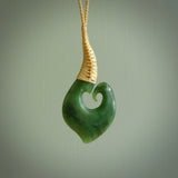This matau, with koru, is carved from a very striking New Zealand jade. It is both intricate and simple in design - it has hidden folds and smooth curves. A piece to be worn or displayed - the carving and the jade are both magnificent. Hand made by Donna Summers.