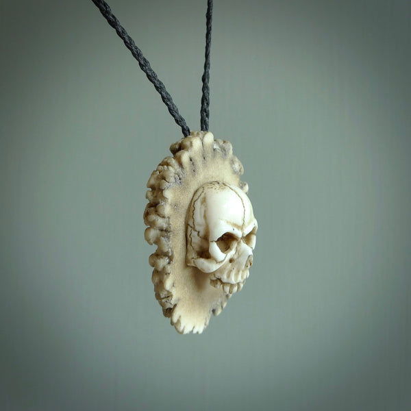 A hand carved SKULL pendant made from a piece of deer antler crown. This is a work of art carved by Fumio Noguchi who is renowned for his skill in bone carving. We deliver this pendant to you on a plaited black cord. Delivery with Express Courier is included in the price.