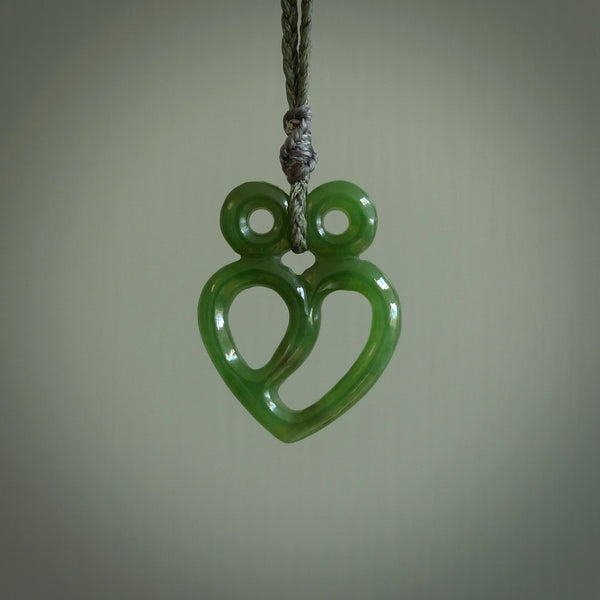 This is a handcarved love heart pendant made from a gorgeous and striking piece of British Columbia Jade stone. This is a superbly carved and very unique piece if custom jewellery. For sale online from NZ Pacific.