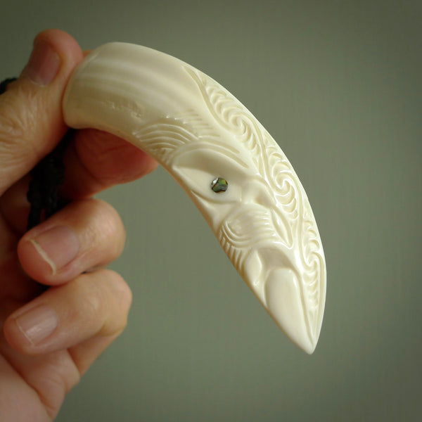 Hand carved engraved boars tusk pendant, carved by us. This particular piece is a contemporary design and is lovingly carved.
