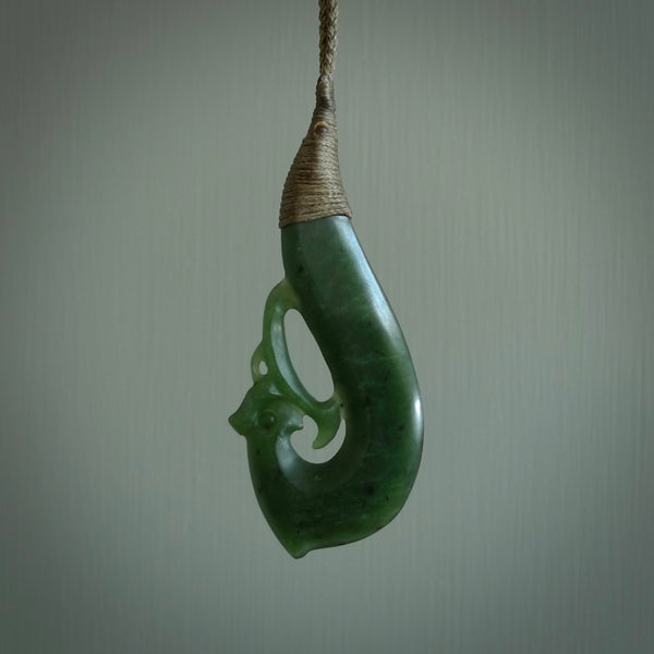This picture shows a contemporary manaia pendant carved for us by Ric Moor. It is a deep green colour in traditional manaia design. We have plaited a cord in olive and made it length adjustable. This is a very beautiful piece of art to wear.