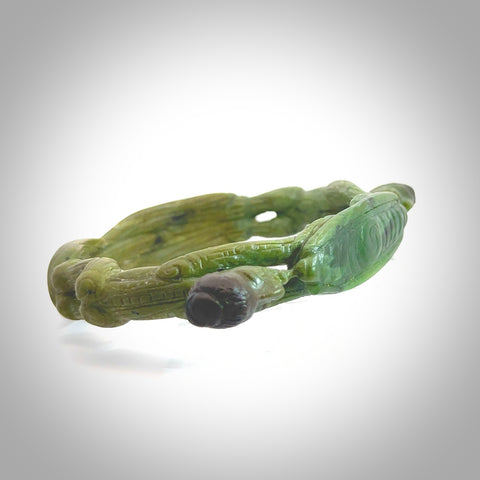 A photo of a New Zealand Jade bangle. This is a one off, statement piece - hand crafted here in New Zealand by Jeromy. Unique Art to Wear. Gifts for all lovers of hand made Art to Wear. One only collectors pendant. Delivery is free worldwide.