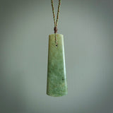 Hand made New Zealand jade drop with koru pendant. Hand carved in New Zealand by Kerry Thompson. Hand made jewellery. Unique large Jade drop with fixed length tan coloured cord. Free shipping worldwide.