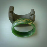 Hand carved jade bangle. Carved from green New Zealand jade. This is a solid jade bangle carved from a single piece of jade. It is polished to a sleek matte. the jade is otherwise untreated and completely natural.