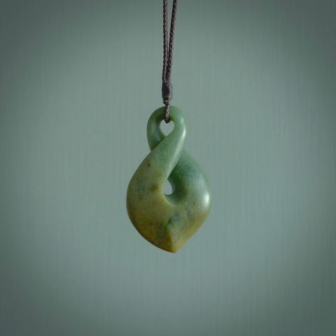 Hand carved medium sized, New Zealand jade twist pendant. Carved in New Zealand by NZ Pacific. Māori themed jewellery for sale online.