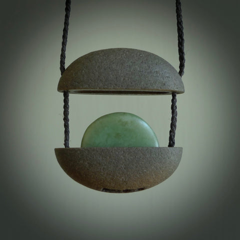 Greywacke stone pendant with New Zealand Inanga Pounamu insert. Hand carved by Rhys Hall for NZ Pacific. Handmade contemporary jewellery for sale online.