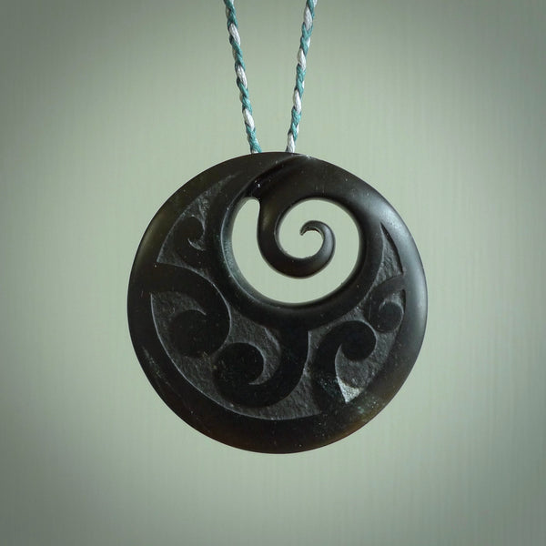 Hand made large New Zealand Pounamu, Jade Koru pendant. Hand carved in New Zealand by Rueben Tipene. Hand made jewellery. Unique large Greenstone Koru with adjustable cobalt blue/maui blue cord. Free shipping worldwide.