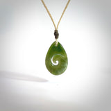 Hand carved New Zealand jade koru drop pendant. Made by NZ Pacific.Hand carved New Zealand jade koru drop pendant. Made by NZ Pacific.