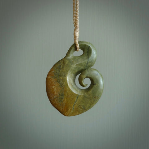 This koru, is carved from a very striking New Zealand flower jade. It is both intricate and simple in design - it has hidden folds and smooth curves. A piece to be worn or displayed - the carving and the jade are both magnificent.