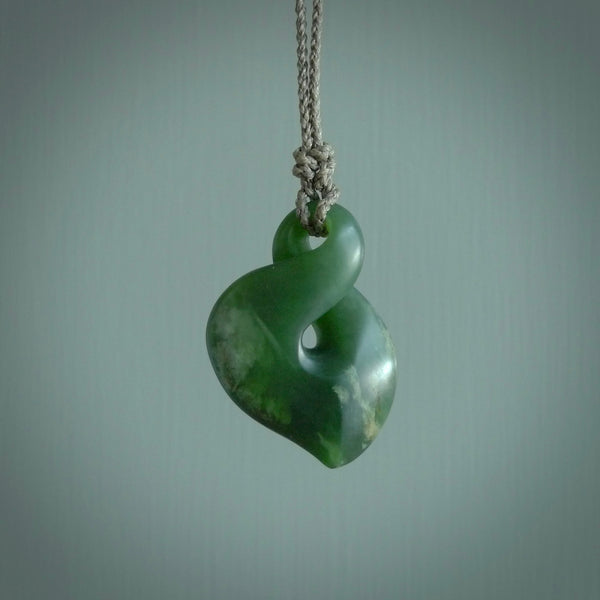 Hand carved medium sized, New Zealand jade twist pendant. Carved in New Zealand by NZ Pacific. Māori themed jewellery for sale online.