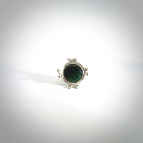This is a handcrafted New Zealand Pounamu, Jade and sterling silver ring. This is a solid little work of art. We ship this worldwide for free and are happy to answer any questions that you may have about these or other products on our website. Delivered with Express courier and packaged in a woven kete pouch.