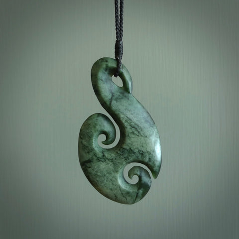 This matau, is carved from a very striking New Zealand Marsden jade. It is both intricate and simple in design - it has hidden folds and smooth curves. A piece to be worn or displayed - the carving and the jade are both magnificent. Hand made by New Zealand Master Carver Donna Summers. Unisex pendants online for sale.