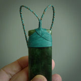 A large and beautiful hand carved toki pendant. This piece is carved from New Zealand jade by NZ Pacific. This is a wonderful large toki bound with a hand-plaited silver and blue cord and a traditional blue lashing. A beautiful, traditional toki for sale online.