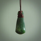 Hand carved from a lovely piece of local New Zealand Jade. The quality of the workmanship and design is outstanding - this is a piece you will want to wear all the time. We have suspended this from a 3-plait brown cord which can be adjusted with a couple of slip knots and brown binding.