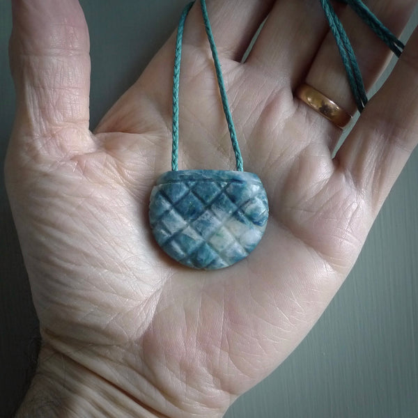 This is a handcrafted aotea stone pendant. This is a solid little work of art. We ship this worldwide for free and are happy to answer any questions that you may have about these or other products on our website.