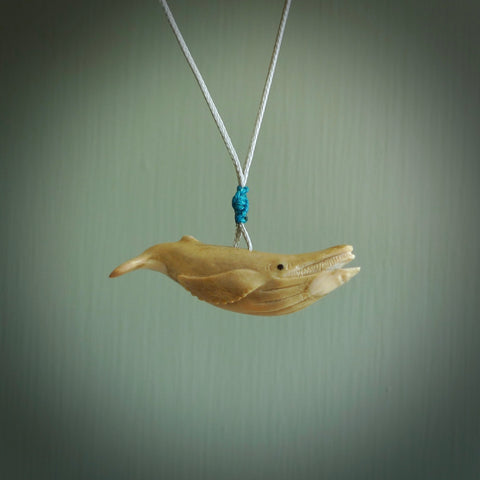 This little whale pendant is handcarved from deer antler. It is a wonderful, smaller piece that replicates a sperm whale breeching the waters surface. We provide this with a hand-plaited fine snowstorm grey necklace cord. Free shipping worldwide.