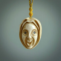 Hand carved incredible stained bone gargoyle face carving. A stunning work of art. This pendant was hand carved in bone with buffalo horn inlay for the eyes by Yuri Terenyi. A one off collectors item that has been hand crafted to be worn or displayed.
