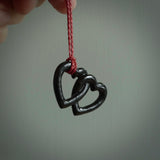 Hand carved double heart pendant made in black jade, green jade and jasper stone. Made by NZ Pacific. Carved from green jade, black jade and red jasper stone. Free delivery worldwide.