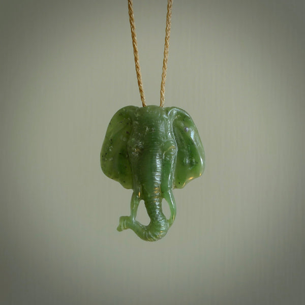 This is a handcarved elephant. Carved in a beautiful darker green piece of New Zealand jade. The cord is hand-plaited and length adjustable in a dark or pale green.