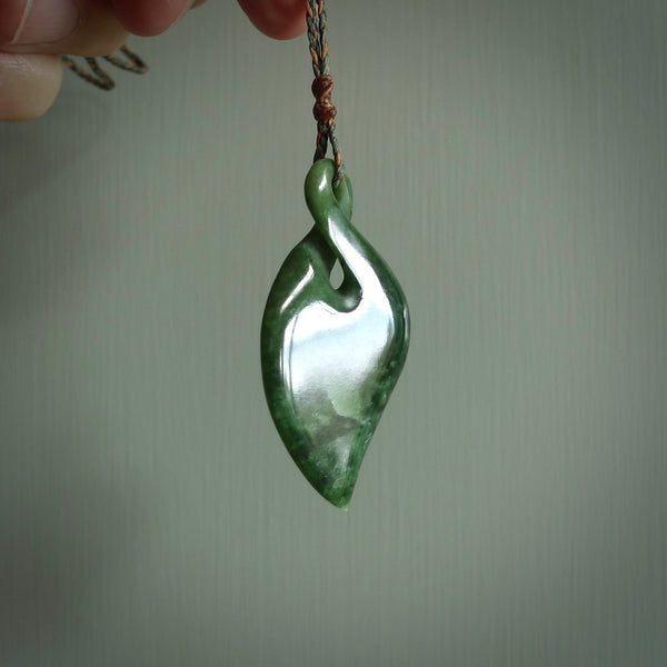 Hand carved New Zealand jade, single twist pendant. Maori pikorua pendant hand carved in New Zealand. Made by NZ Pacific, jade jewellery for sale online. One only hand made by Ross Crump.
