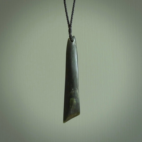 This photo shows a large jade drop shaped pendant. It a a lovely deep green jade. The cord is a four plait black and is adjustable in length. One only large, contemporary drop necklace from Jade, by Ric Moor.