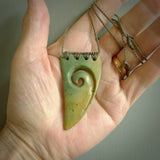 Hand carved New Zealand Flower jade niho, fang, pendant with Koru heart centre. Carved by New Zealand artist Ric Moor. Contemporary New Zealand Jade fang, drop necklace with Koru centre. One only unique pendant for men and women.