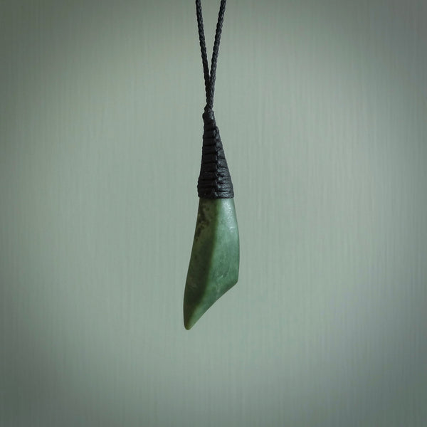 A lovely medium sized New Zealand jade drop pendant. This piece is made from a light, mint green jade and is a wonderful light green colour. Carved by Ric Moor for NZ Pacific and delivered worldwide.
