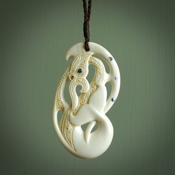 Bone carving of a taniwha. A three dimensional pendant carved in bone by Andrew Doughty. One only taniwha carving for men and women. Provided with an adjustable cord.