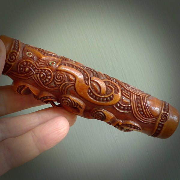 A traditional hand carved Māori Kōauau flute. This piece is made from bone and is a fully functioning musical instrument and can be played. Beautiful ethnic art hand made by NZ Pacific. One only traditional flute by Yuri Terenyi.