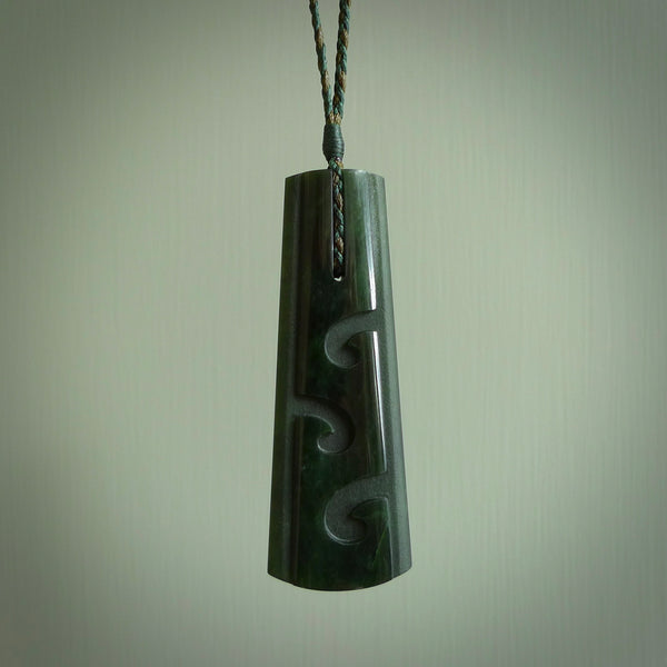 Hand made New Zealand jade drop with koru pendant. Hand carved in New Zealand by Kerry Thompson. Hand made jewellery. Unique large Jade drop with fixed length Manuka/Olive coloured cord. Free shipping worldwide.