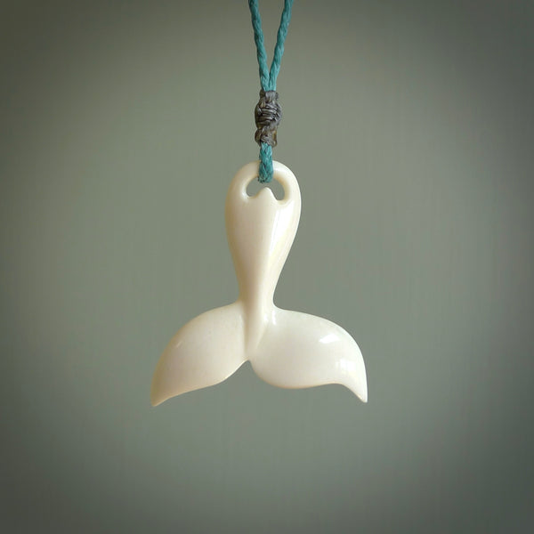 Hand carved bone whale tail pendant. Made by NZ Pacific. Bone whale tail necklace with adjustable cord.